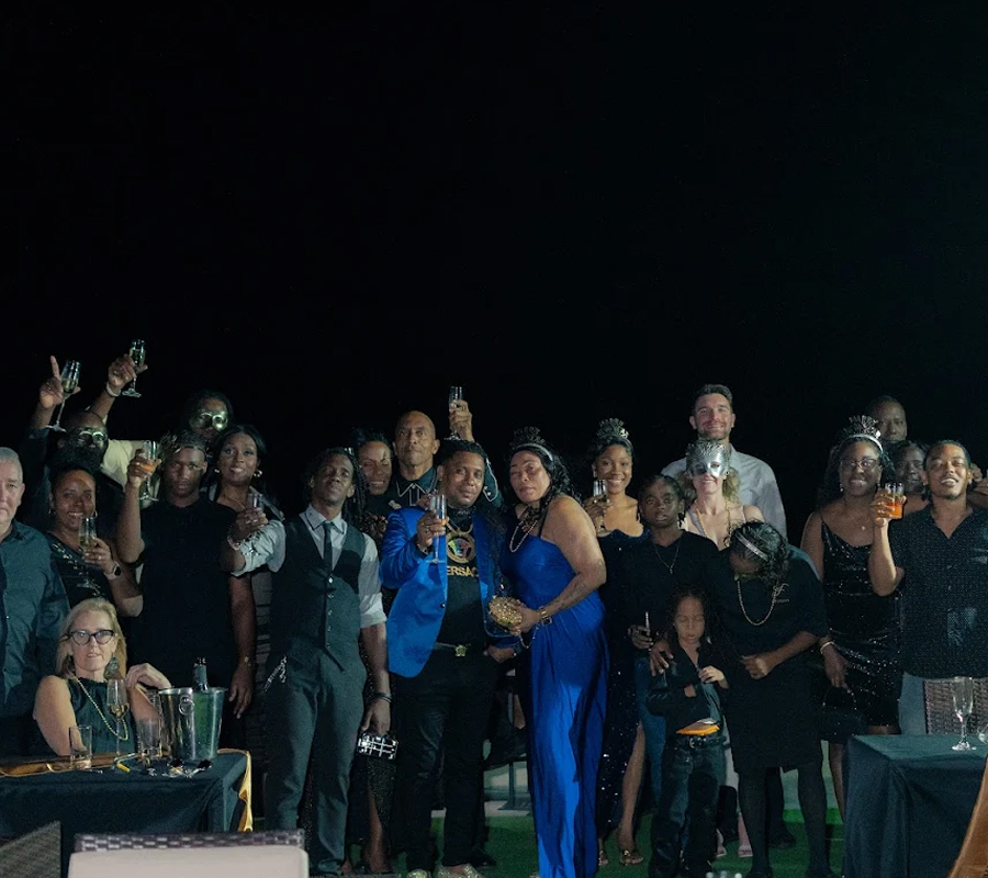 Large group celebrating a private birthday party in St. Lucia at Felicity Rooftop Restaurant with drinks and a festive nighttime atmosphere
