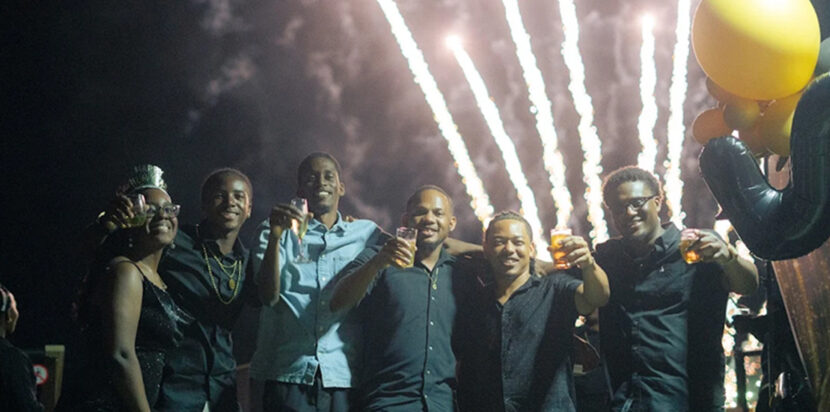 Friends celebrating at a private event place in St. Lucia with cocktails and fireworks at Felicity Rooftop Restaurant